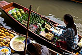 Thailand, Locals sell fruits, food and products at Damnoen Saduak floating market near Bangkok 
